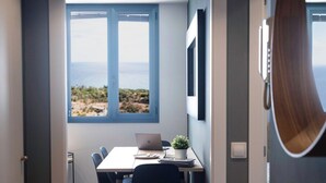 A modern dining area with a table, chairs, and a laptop. - Home2Book Stunning&Design Apartment Santa Cruz (Santa Cruz de Tenerife)