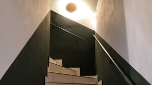 A staircase with a modern design, featuring a handrail and a light fixture at the top. - Diamond Forest - 8 Full Beds Summercard Included (Kaprun)