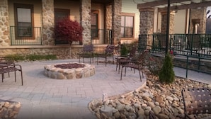 A courtyard with stone walls, outdoor seating, and a fire pit. - 1BD/Sevierville - Smoky Mountains Resort w/pools! (Sevierville)