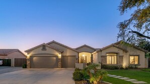 A two-story house with a garage, a well-maintained lawn, and a stone pathway leading to the entrance. - Luxury Home, Beautiful Neighborhood, Spacious for Family, with Pool/Spa.  (Glendale)