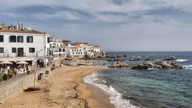 A coastal town with white buildings, a sandy beach, and rocky outcrops in the sea. - Casa Coene, a charming, fully equipped Spanish house (Pals)