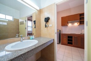 A bathroom with a sink, mirror, hairdryer, and toiletries. - Jungceylon Villa in Patong by Lofty (Patong)