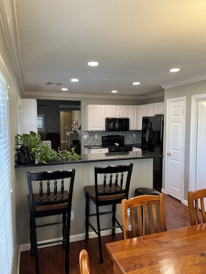 Enjoy cooking in this well-equipped kitchen with a refrigerator, microwave, and dining table.