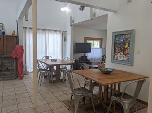 Relax in this open-plan living space with a dining area, flat-screen TV, and comfortable seating.