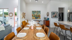A modern kitchen with a dining area.