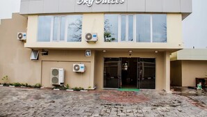 A building with the sign 'Sky Suites' above the entrance. There are air conditioning units mounted on the exterior walls. - Sky Suites (Lagos)