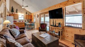 A cozy cabin interior with a living room, dining area, and kitchen. - Cupid's Haven: Private Cabin Close To All (Sevierville)