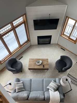 A living room with a fireplace, two armchairs, a sofa, and a coffee table. - Fantastic 3 bed, 2 bath Lake Miltona Home near famed sandbar. Sleeps 10. Lic2114 (Alexandria)