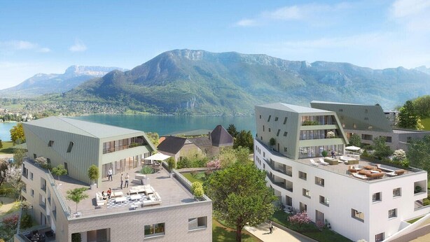 A modern building complex with multiple floors, large windows, and outdoor terraces. - The nest of Lake Annecy (Annecy)
