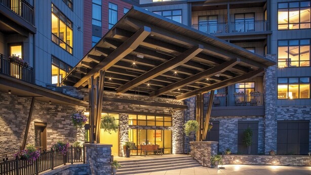 A hotel entrance with a covered patio, stone facade, and a staircase leading to the entrance. - Club Wyndham Resort at Avon (Avon)
