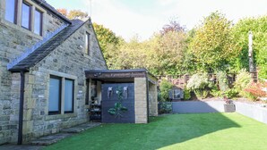 A stone building with a small garden area in front. - Moor Cottage (Oldham)