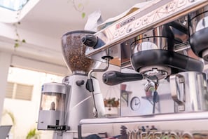 A coffee machine with a digital display and a grinder.