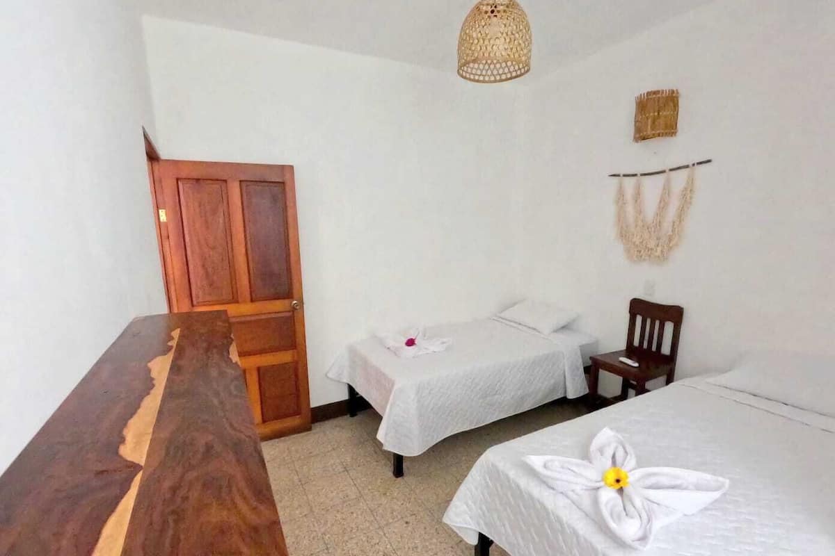 Desk, laptop workspace, iron/ironing board, bed sheets