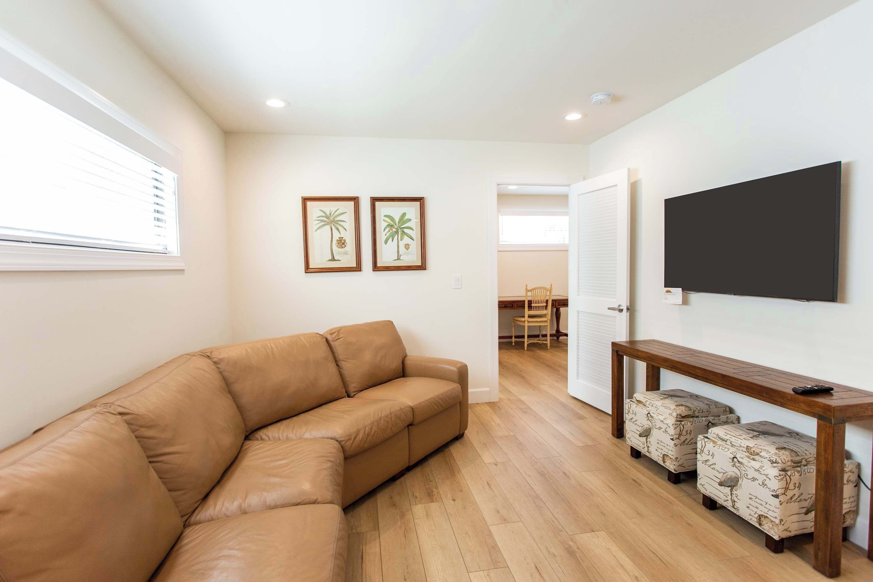 Upstairs lounging area with comfy sofas and TV