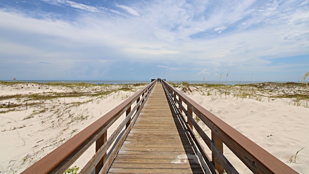 A wooden boardwalk leading to the beach with dunes and sparse vegetation. - What if I told you…You CAN afford Paradise! Make the Call today! 🤙 (Gulf Shores)