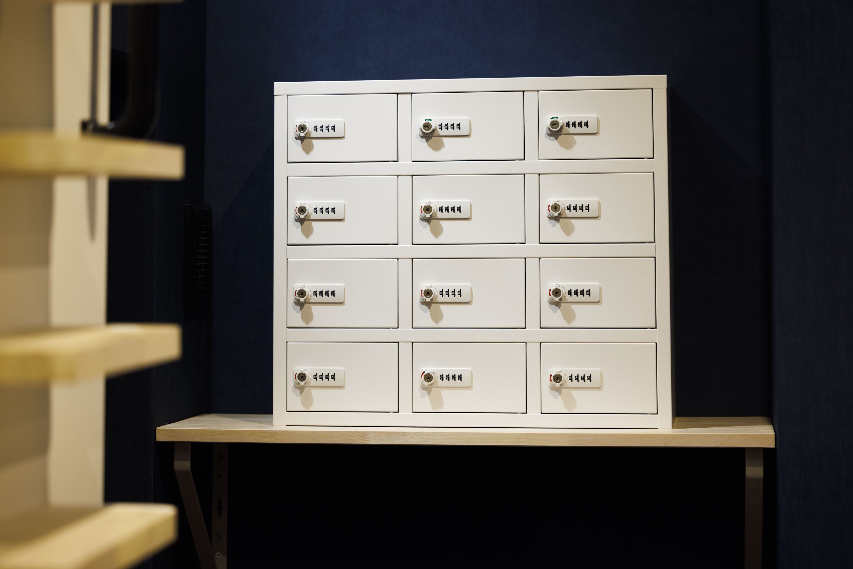 A white filing cabinet with multiple drawers, each labeled with text.