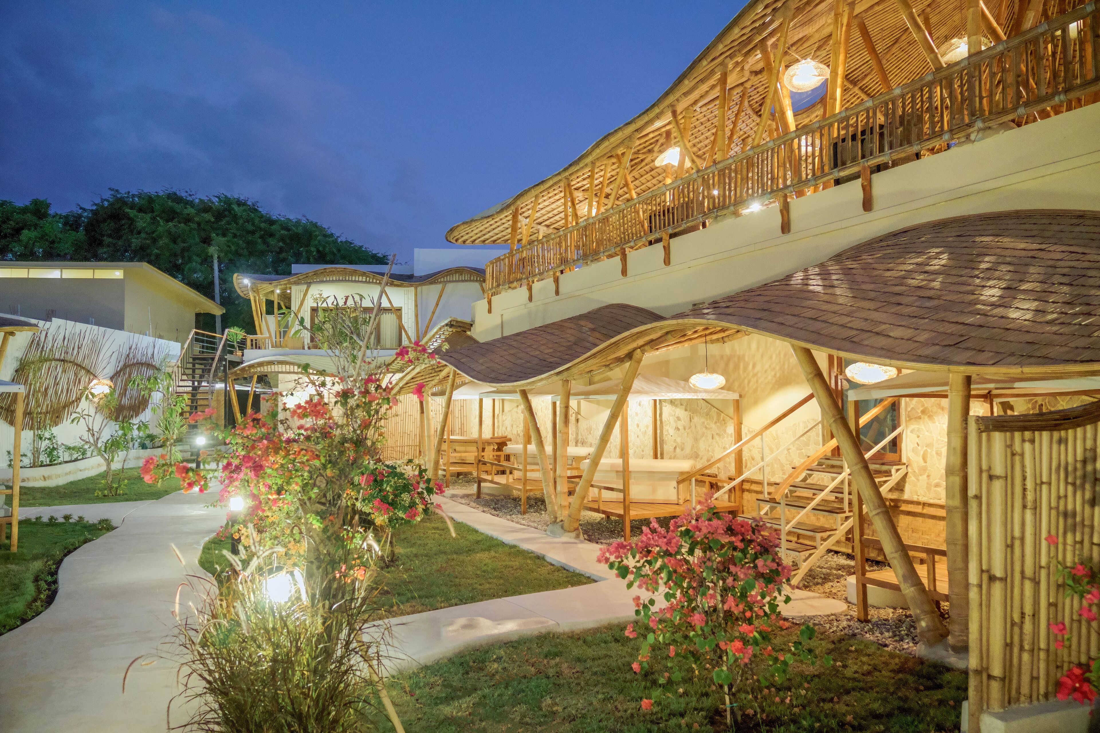 A modern building with a wooden structure, outdoor seating, and a pathway.