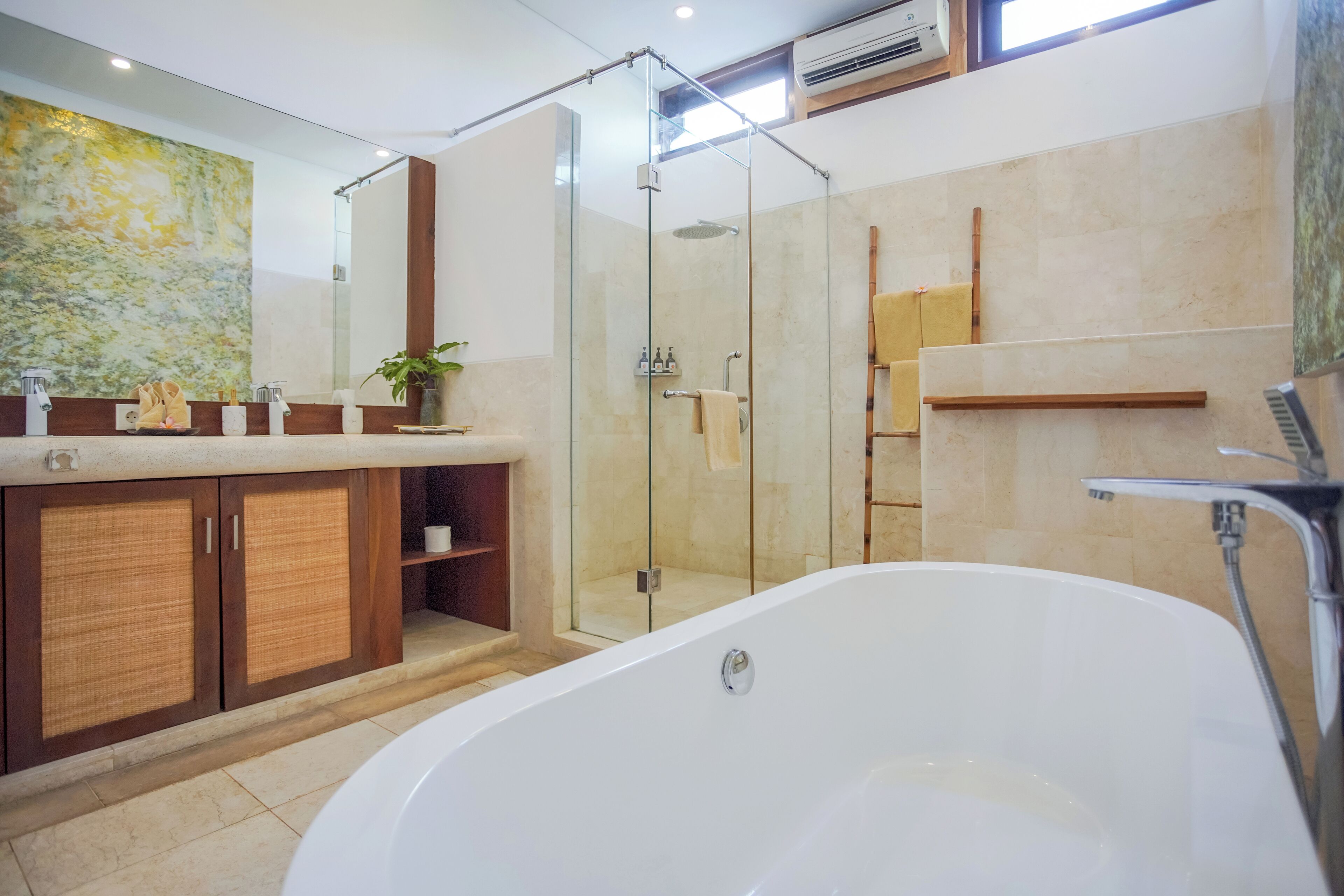 Une salle de bain moderne dotée d’une douche à parois de verre, d’une baignoire sur pieds et d’un meuble-lavabo en bois avec un grand miroir.