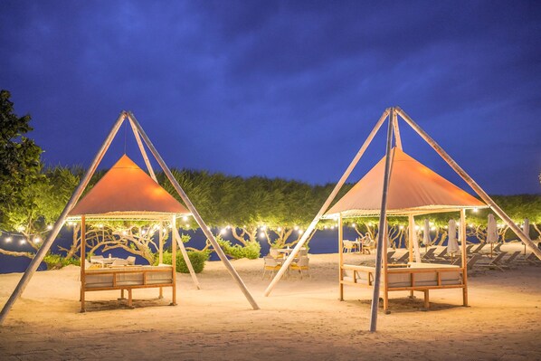 On the beach, white sand, sun-loungers, beach umbrellas