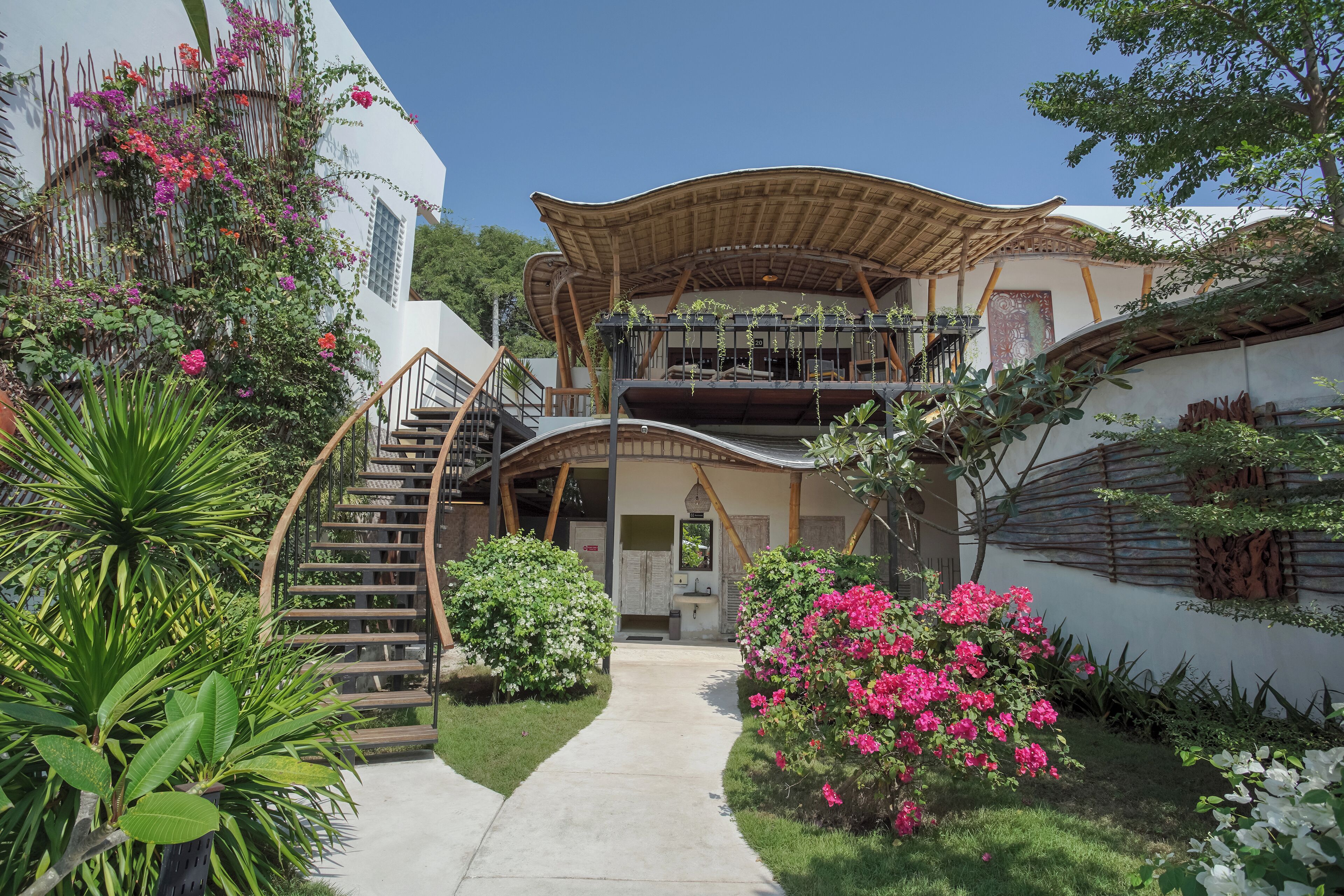 A two-story building with a curved roof and a central staircase.