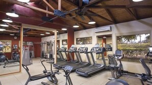 A gym with treadmills, elliptical machines, and weight equipment.