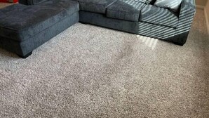 A sectional sofa with a grey and blue patterned accent, a light grey throw pillow, and a grey carpeted floor. - Beautiful, Large 4 bedroom Home in Anna Tx (Anna)