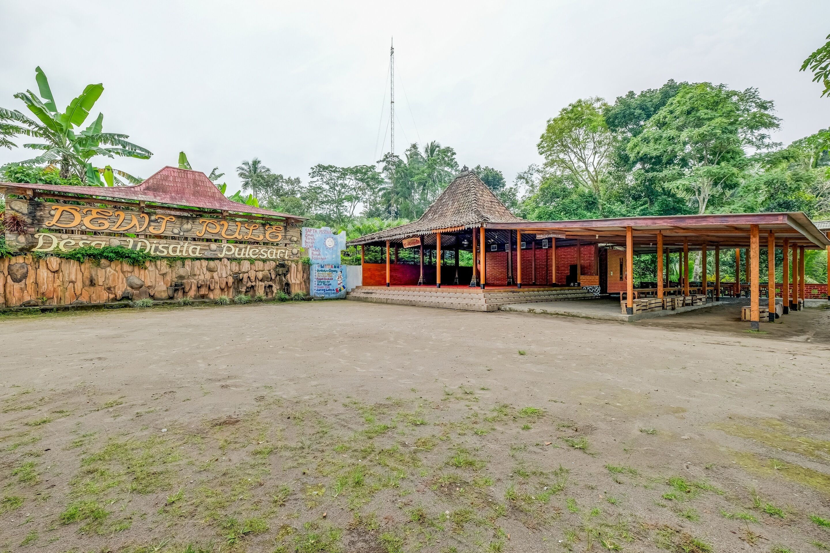 A rustic building with a sign reading "Deini's Pulled Disata Pulasa."