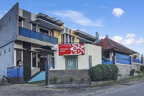 A modern two-story building with a prominent sign for "Forzando House." - OYO Living 90950 Forzando House (Malang)