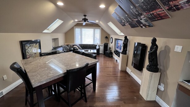 A spacious kitchen with a large island, wooden flooring, and modern appliances. - Unique spacious upper Condo Suite. Steps from waterfront  (Sarnia)