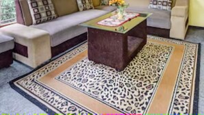 A living room with a sofa, a coffee table, and a patterned rug. - Hotel O Kampung Wisata Ekologi Puspa JagadNearGunung Kelud (Gandusari)