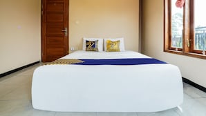 A bedroom with a large bed, a wooden door, and a window with curtains. - OYO Homes 91008 Eco Tourism Desa Cibodas Babakan Gentong 1 Syariah (Lembang)