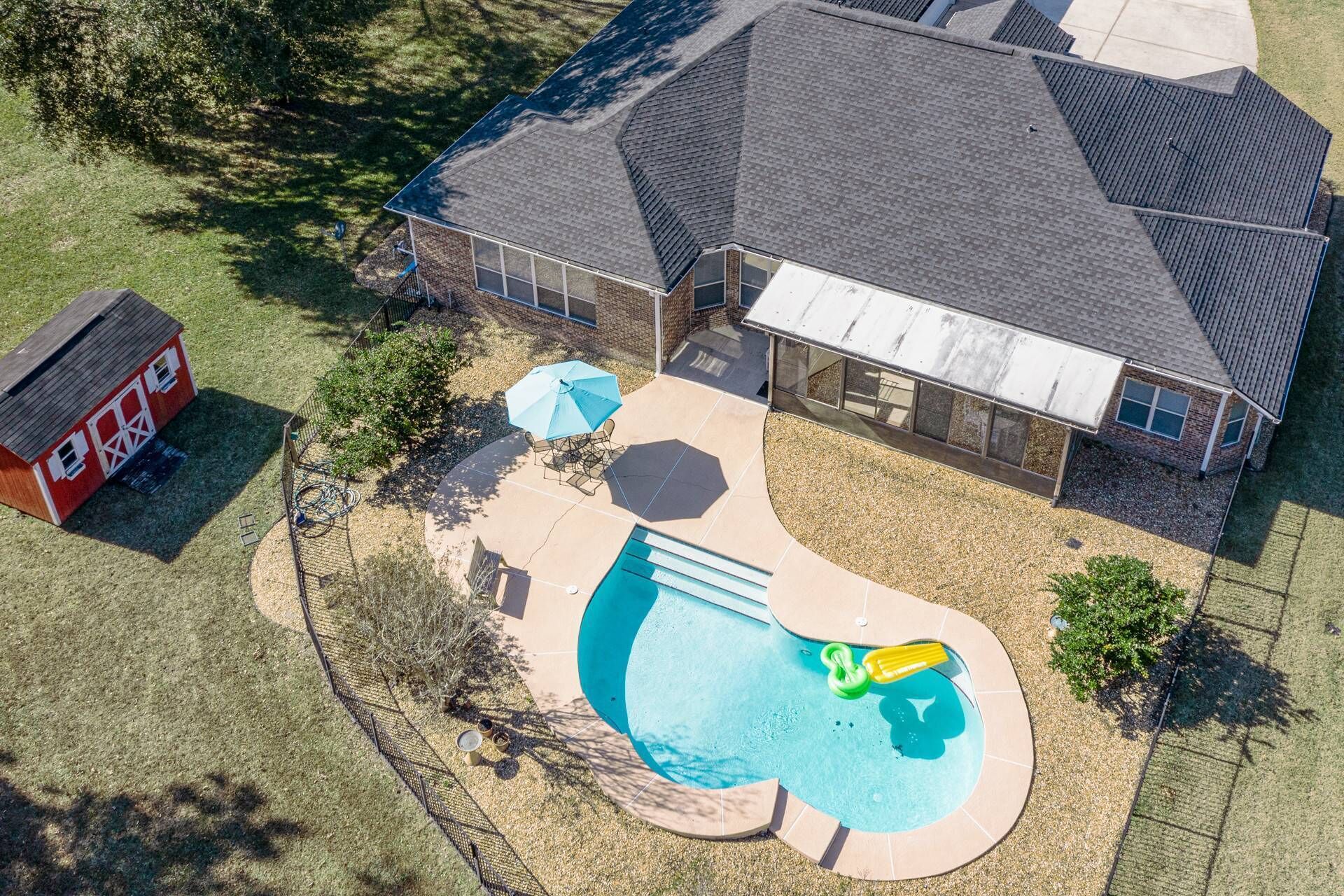 Backyard Oasis: Dive into fun with a shimmering pool and inviting lounge area!