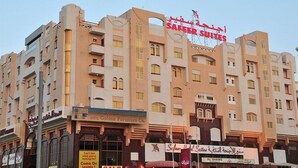 A multi-story hotel with a prominent sign for "SAFFER SUITES".