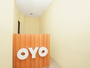 Welcome to OYO, where guests are greeted by a friendly reception desk.