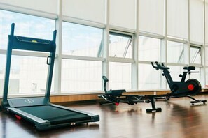 A gym with exercise equipment including a treadmill and an elliptical machine. - Inner Mongolia Hotel Duolan Hotel (Jinqiao Development Zone) (Hohhot)