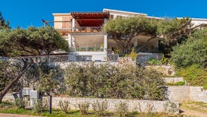 A two-story building with a balcony and a covered terrace. - Bellavista Paradise 2 (Marinella)