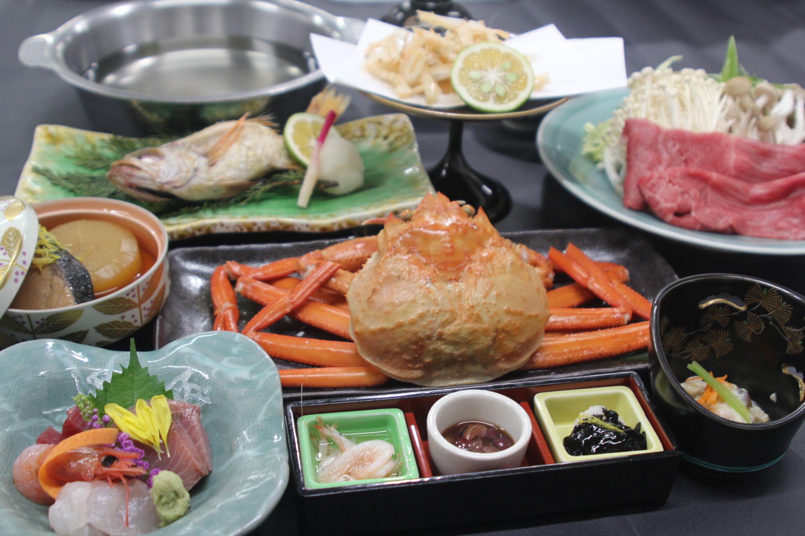 A variety of seafood dishes including shrimp, crab, and fish, served on different plates and bowls.