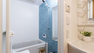 Separate tub and shower, hair dryer, slippers, towels