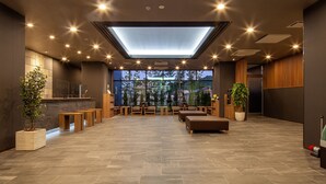 A spacious lobby with a skylight, seating areas, and a reception desk. - Hotel Route-Inn Shunan-Tokuyama Higashi Inter- (Shunan)