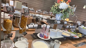 A buffet setup with various food items and condiments. - Hotel Route Inn Shikoku Chuo - Mishimaka (Shikokuchuo)
