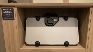 A suitcase in a wooden display case with a sign in Japanese.