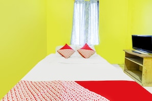 A room with a bed, a television on a wooden stand, and a window with a curtain. - Hotel O Emes Jaya HomestayNearSamsung Electronic Indonesia PT (Batam)