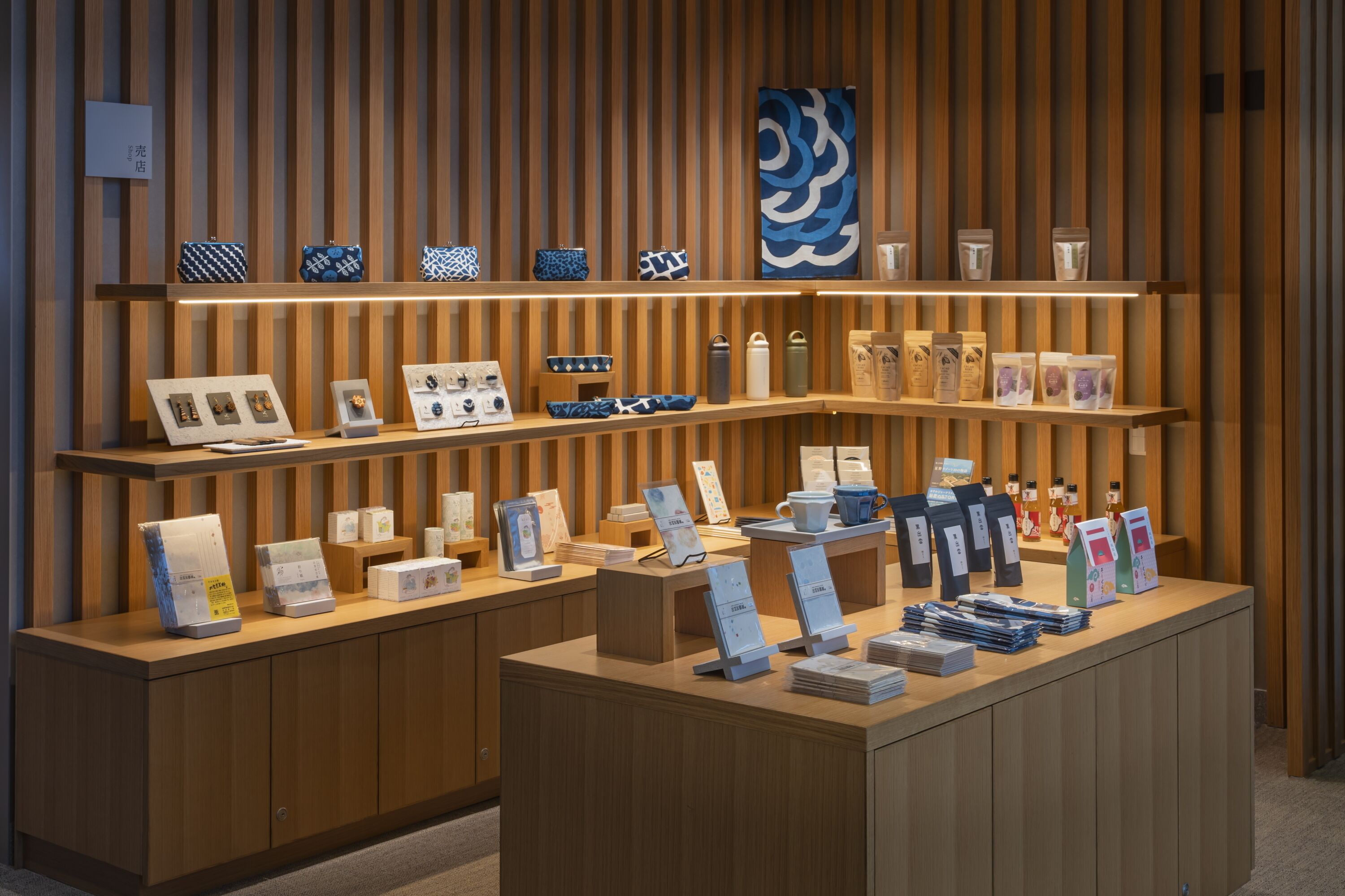 A display of various products on wooden shelves and counters, including bags, boxes, and decorative items.