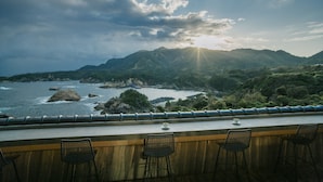 A seaside restaurant with a view of the ocean and mountains. - Hoshino Resorts KAI Izumo (Izumo)