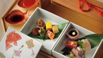Una comida japonesa tradicional con varios platos sobre una bandeja de madera.