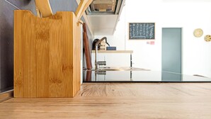 A wooden object, possibly a cutting board, in a kitchen with a modern design, a chalkboard with writing, and a door. - Kolossoi Guest House (Cabras)