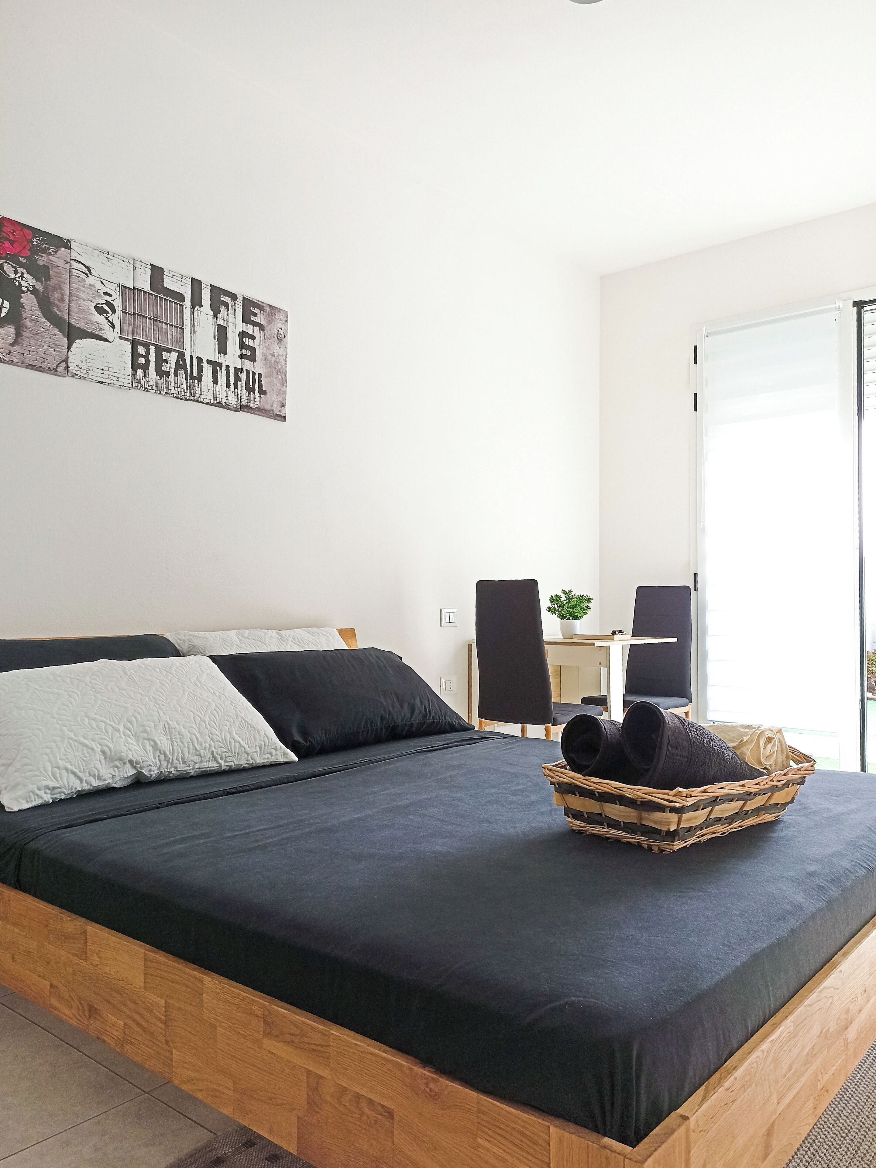 A bedroom with a bed, a desk, and a chair.