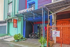 A building with a sign reading "Favorite" and a motorcycle parked outside.