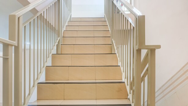 A staircase with beige steps and white railings. - OYO 91316 Hh Guest House Makassar (Makassar)