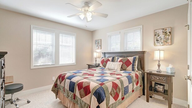 A bedroom with a bed, two bedside tables, a ceiling fan, and a window with blinds. - Wintergreens R910- Mtn Condo/View, Gated Resort, Indoor/Outdoor Pools & Hot Tub (Banner Elk)